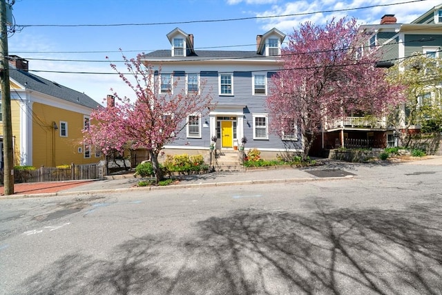 view of front of home featuring fence