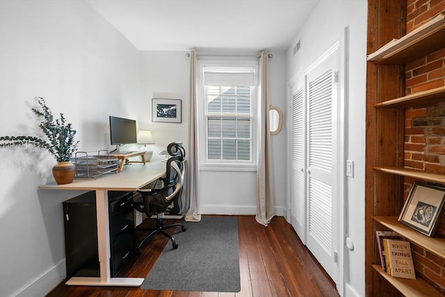 office featuring baseboards, dark wood-style flooring, and visible vents