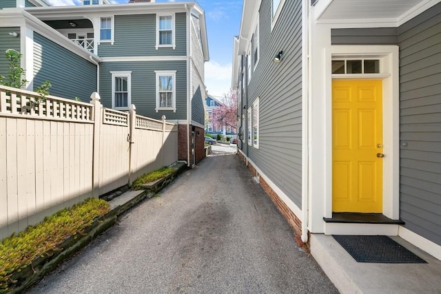 exterior space featuring fence and aphalt driveway