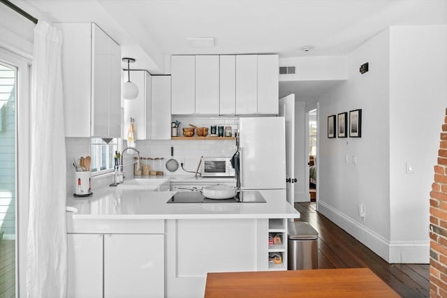 kitchen with white cabinets, open shelves, a sink, white appliances, and dark wood-type flooring