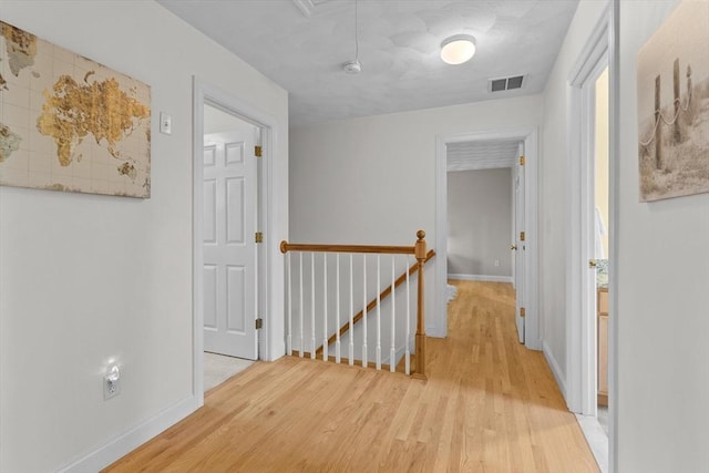 8 Mill River Ln, Rowley, MA 01969 - corridor featuring an upstairs landing, light wood-type flooring, and attic access