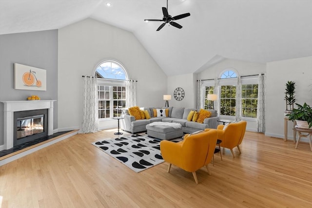8 Mill River Ln, Rowley, MA 01969 - living area featuring vaulted ceiling, wood finished floors, a ceiling fan, and a glass covered fireplace