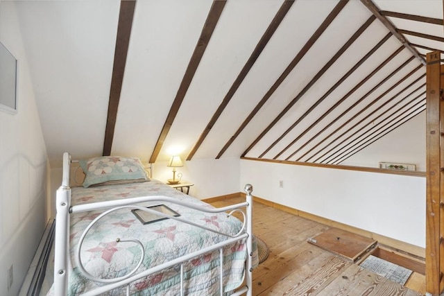 bedroom with vaulted ceiling and wood-type flooring