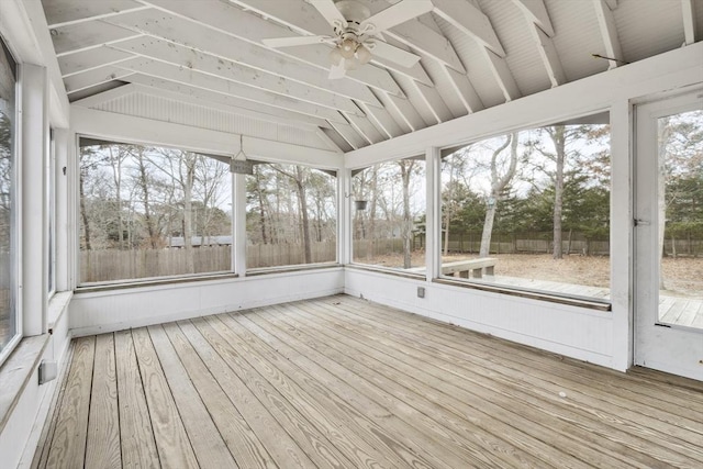 unfurnished sunroom with vaulted ceiling and a ceiling fan