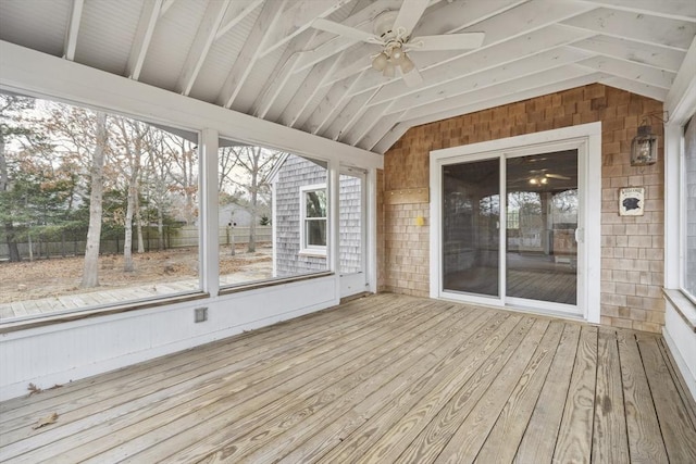 unfurnished sunroom with lofted ceiling, plenty of natural light, and a ceiling fan