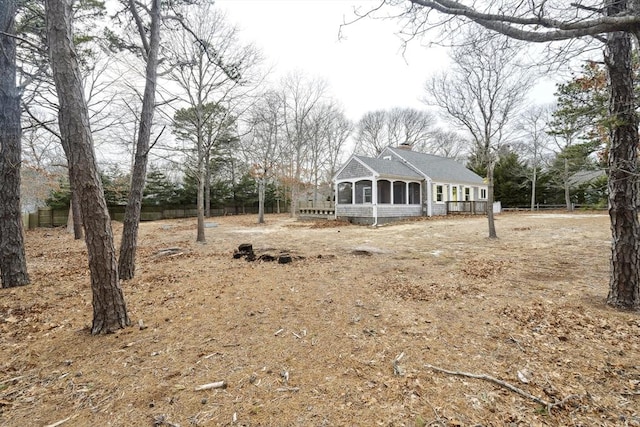 view of front of house with a sunroom and a chimney