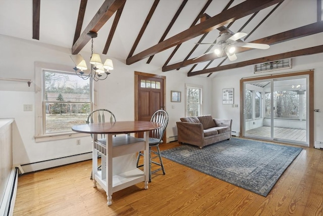 dining space featuring a baseboard radiator, a healthy amount of sunlight, baseboard heating, and wood finished floors