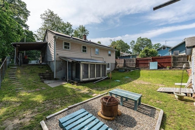 14 Bayside St, Springfield, MA 01109 - back of property with a sunroom, a fire pit, and a chimney