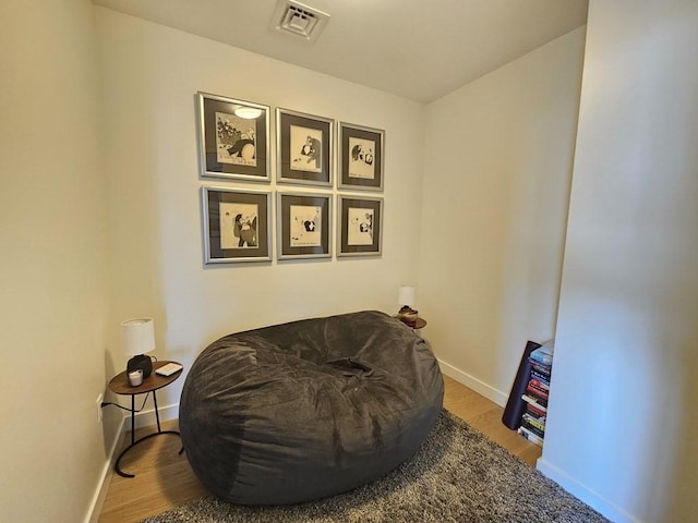 living area with hardwood / wood-style floors