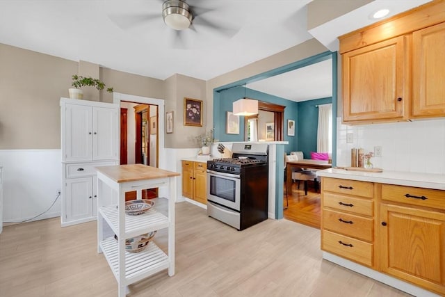 50 Oleander St, West Springfield, MA 01089 - kitchen with gas range, ceiling fan, light countertops, light wood-style flooring, and backsplash