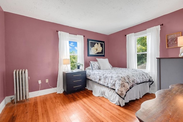 50 Oleander St, West Springfield, MA 01089 - bedroom with radiator, wood finished floors, and a textured ceiling