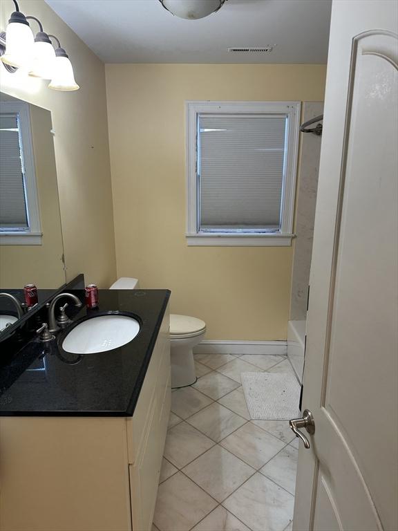 full bathroom with visible vents, toilet, shower / bathtub combination, tile patterned floors, and vanity