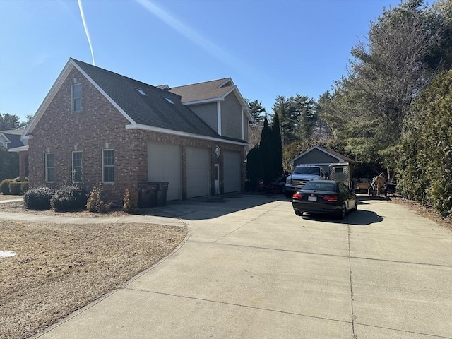 view of home's exterior featuring brick siding, an attached garage, and concrete driveway