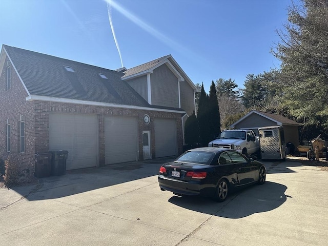 view of property exterior featuring brick siding, an attached garage, concrete driveway, and roof with shingles