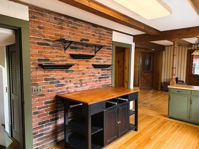 interior space with beam ceiling, light wood-style flooring, and butcher block countertops