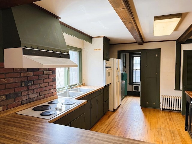 kitchen with custom range hood, white appliances, radiator heating unit, light wood finished floors, and a sink