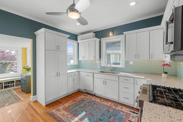 2 Howland Ave, Dartmouth, MA 02748 - kitchen featuring a sink, white dishwasher, white cabinetry, healthy amount of natural light, and ornamental molding