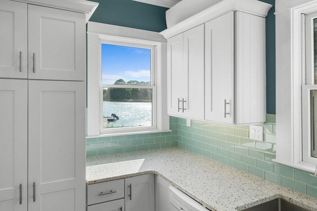 2 Howland Ave, Dartmouth, MA 02748 - kitchen with tasteful backsplash, white cabinets, light stone countertops, and dishwasher