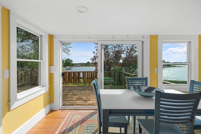 2 Howland Ave, Dartmouth, MA 02748 - dining room with a water view, wood finished floors, healthy amount of natural light, and baseboards