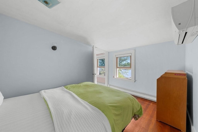 2 Howland Ave, Dartmouth, MA 02748 - bedroom with an AC wall unit, a baseboard radiator, wood finished floors, and lofted ceiling