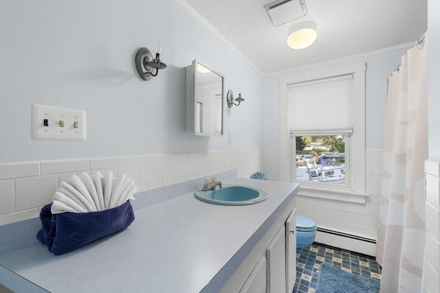 2 Howland Ave, Dartmouth, MA 02748 - full bath featuring a baseboard heating unit, ornamental molding, tile walls, vanity, and toilet