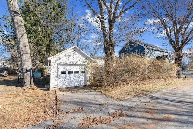 view of property exterior featuring a garage and an outdoor structure