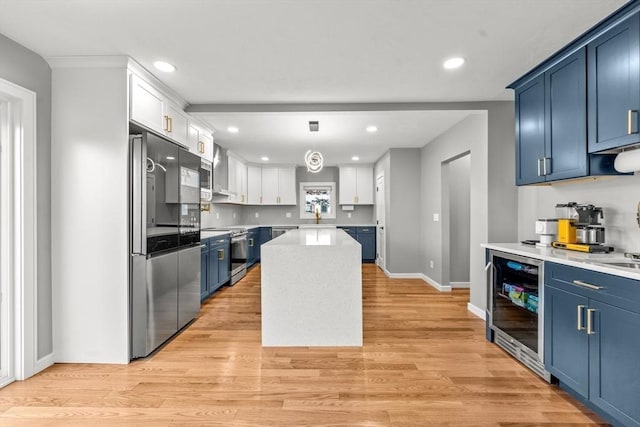 kitchen with white cabinetry, a center island, stainless steel appliances, wine cooler, and blue cabinets