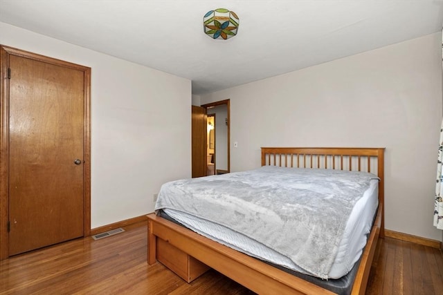 bedroom with hardwood / wood-style flooring