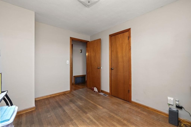 unfurnished room featuring wood-type flooring