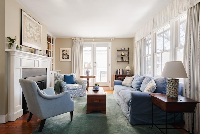 sitting room with french doors and dark wood-type flooring