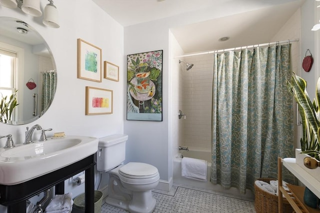 full bathroom featuring sink, toilet, and shower / bath combination with curtain