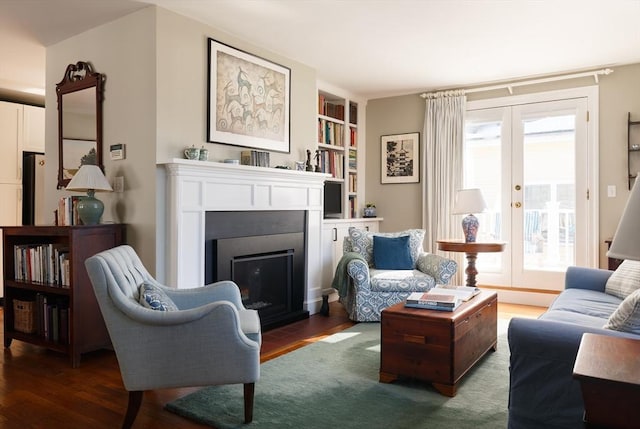 living room with built in features, french doors, and dark wood-type flooring