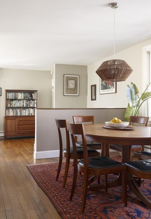 dining space featuring hardwood / wood-style flooring and a baseboard heating unit