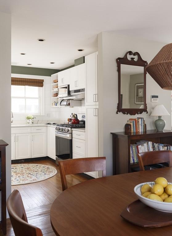 kitchen featuring exhaust hood, white cabinetry, gas stove, and dark hardwood / wood-style floors