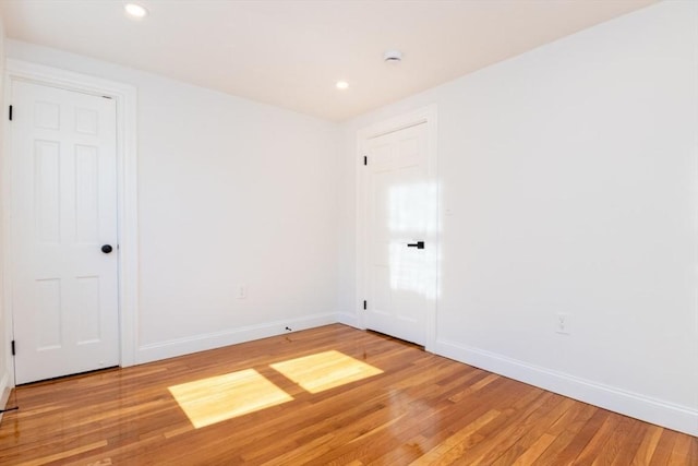 unfurnished room with recessed lighting, light wood-style flooring, and baseboards