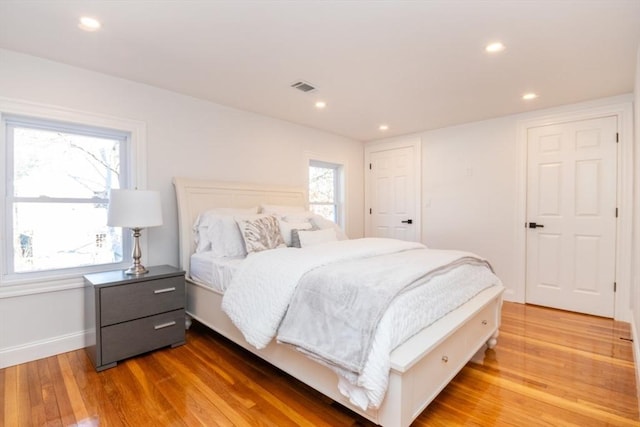 bedroom featuring light wood-type flooring, visible vents, and recessed lighting