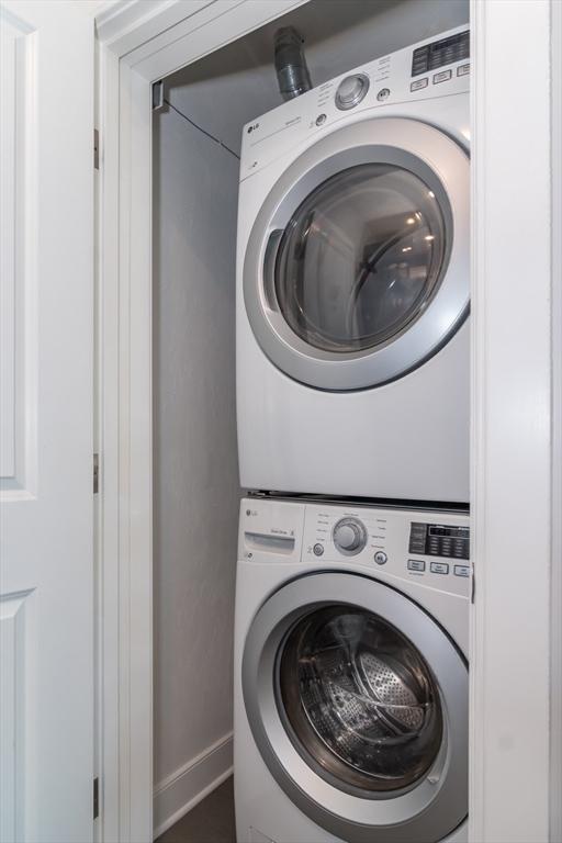 laundry room featuring stacked washer and clothes dryer