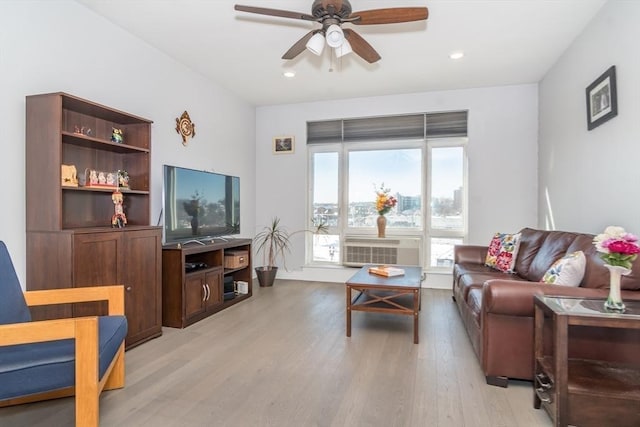 living room with light wood-type flooring and ceiling fan