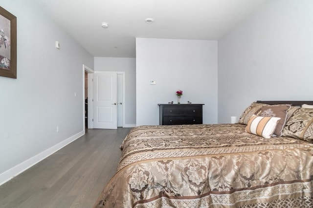 bedroom with dark hardwood / wood-style flooring