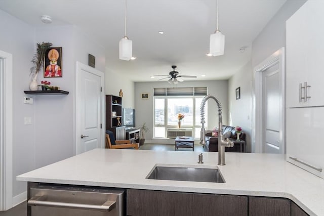 kitchen with sink, dark brown cabinetry, dishwasher, and pendant lighting