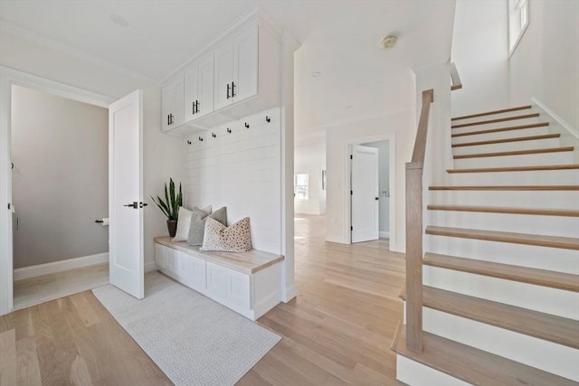 mudroom featuring light wood-type flooring and baseboards