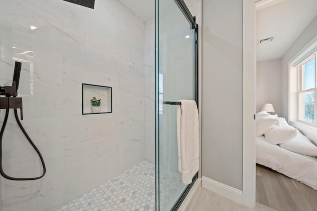 full bath featuring visible vents, ensuite bathroom, a stall shower, wood finished floors, and baseboards