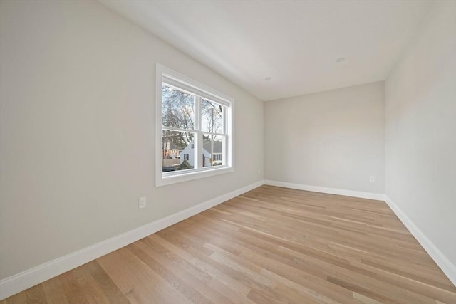 unfurnished room featuring light wood-type flooring and baseboards