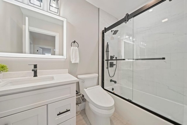 bathroom with toilet, enclosed tub / shower combo, and vanity