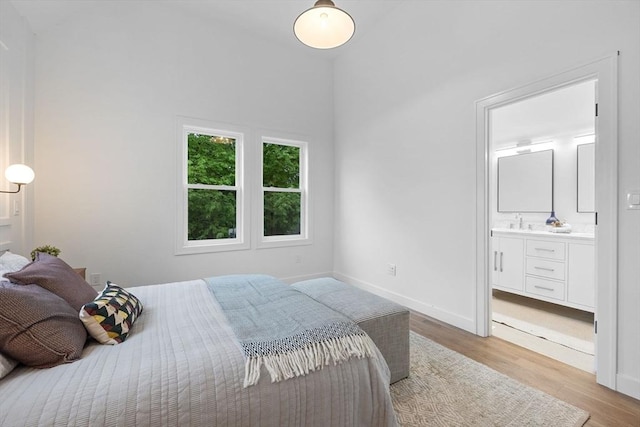 16 Edgar Ave, Somerville, MA 02145 - bedroom featuring light wood-type flooring, a sink, baseboards, ensuite bath, and vaulted ceiling