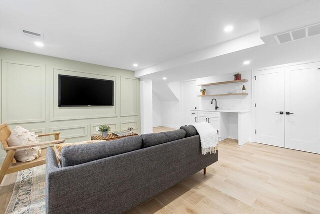 16 Edgar Ave, Somerville, MA 02145 - living room with wet bar, light wood-style flooring, and recessed lighting