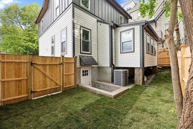 16 Edgar Ave, Somerville, MA 02145 - rear view of house with board and batten siding, central AC, and a gate