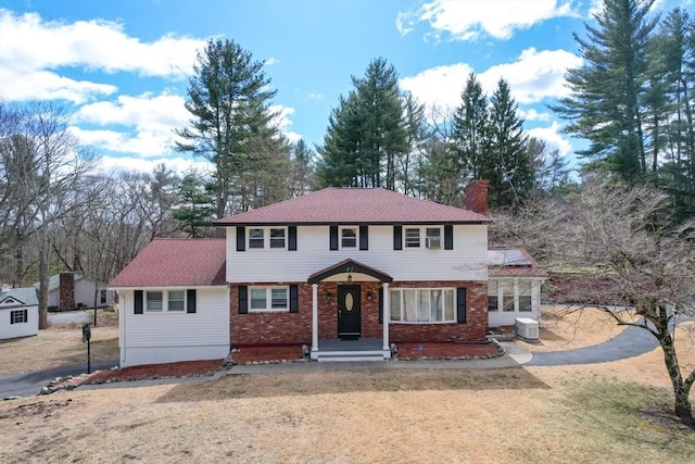 41 Plain Rd, Westford, MA 01886 - view of front of property with a chimney, brick siding, and a front yard