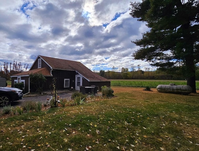 view of property exterior with a lawn