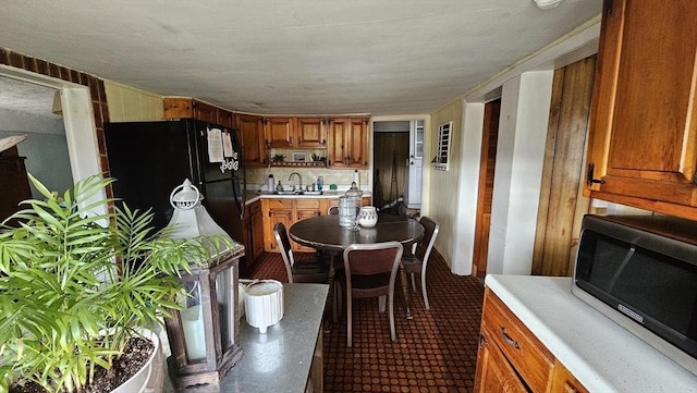 kitchen featuring sink and black fridge